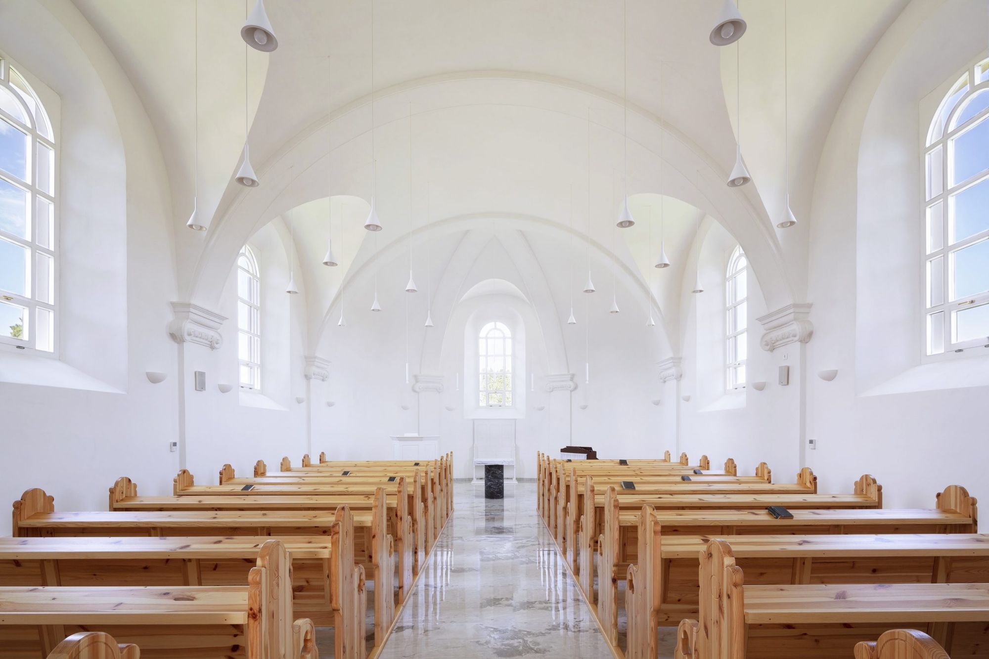 Puritan, yet elegant church interior designed by Studio Bunyik