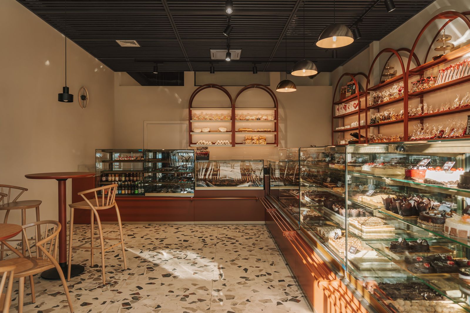 A chocolate-like pattern adorns the floor tiles of this cozy Polish patisserie