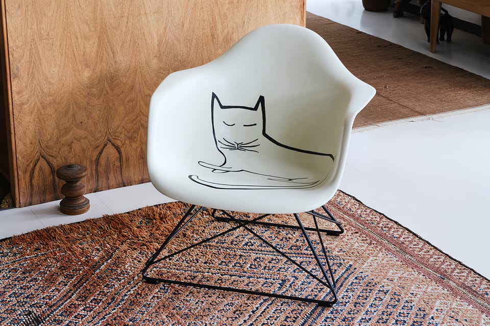Saul Steinberg’s cat cozies up on the Eames armchair