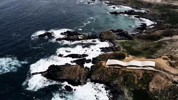 House with the waves of the ocean on its top